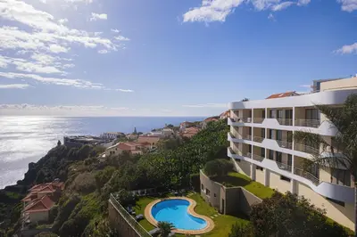 a view of the ocean from a building at New Calheta Plaza Apartment by Your Madeira Rentals in Estreito da Calheta