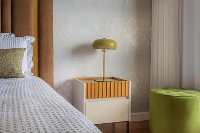 a bedroom with a bed and a lamp on a night stand at New Calheta Plaza Apartment by Your Madeira Rentals in Estreito da Calheta