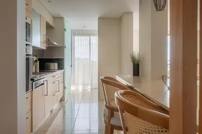 a kitchen with a table and chairs in a room at New Calheta Plaza Apartment by Your Madeira Rentals in Estreito da Calheta