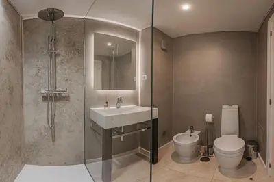 a bathroom with a sink and a toilet and a shower at New Calheta Plaza Apartment by Your Madeira Rentals in Estreito da Calheta