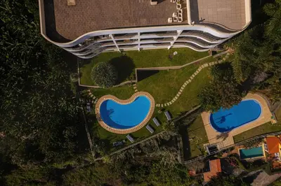 an overhead view of two swimming pools in a park at New Calheta Plaza Apartment by Your Madeira Rentals in Estreito da Calheta