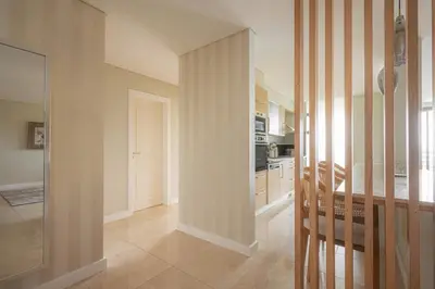 a room with a hallway with a kitchen and a staircase at New Calheta Plaza Apartment by Your Madeira Rentals in Estreito da Calheta
