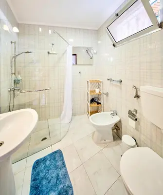 a bathroom with a sink and a toilet and a shower at S&I Chillhouse Funchal in Funchal