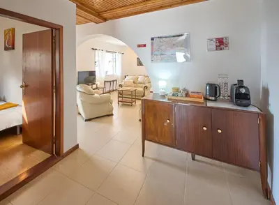 a living room with a wooden cabinet and a living room at S&I Chillhouse Funchal in Funchal
