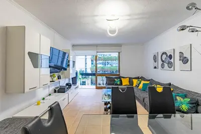 a living room with a couch and a tv at MG Hollidays - Av Infante Funchal in Funchal