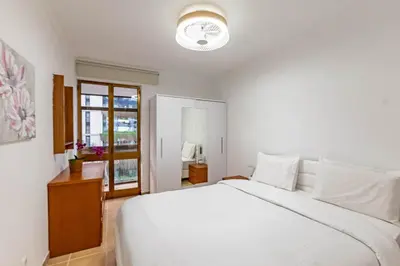 a white bedroom with a white bed and a window at MG Hollidays - Av Infante Funchal in Funchal