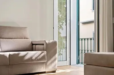 a living room with a couch and a balcony at Solar dos Reis in Funchal