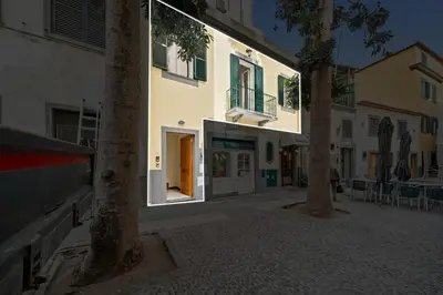 a street with a building with trees in front of it at Solar dos Reis in Funchal
