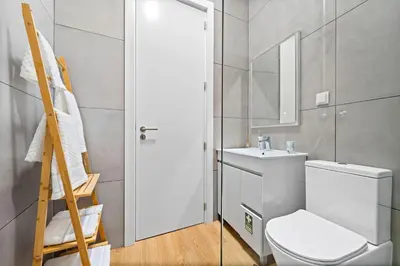 a bathroom with a toilet and a sink and a mirror at Solar dos Reis in Funchal