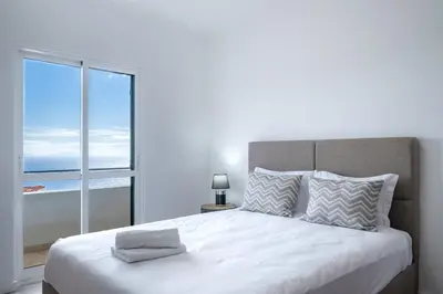 a bedroom with a large bed with a large window at GuestReady - Charming stay with beautiful views in Santa Cruz