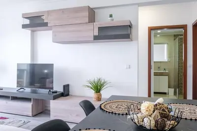 a living room with a table and a tv at GuestReady - Charming stay with beautiful views in Santa Cruz