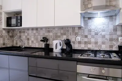 a kitchen with white cabinets and a counter top at GuestReady - Charming stay with beautiful views in Santa Cruz