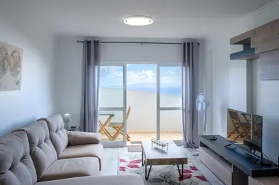 a living room with a couch and a view of the ocean at GuestReady - Charming stay with beautiful views in Santa Cruz