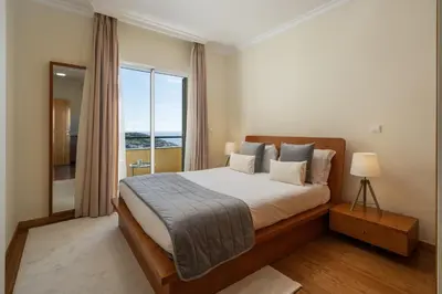 a bedroom with a large bed and a large window at Pico Views by An Island Apart in Câmara de Lobos