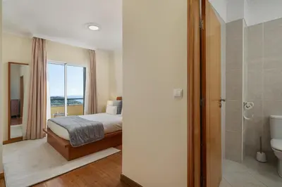 a bedroom with a bed and a bathroom with a shower at Pico Views by An Island Apart in Câmara de Lobos