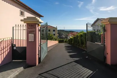a gate to a street with a fence at Pico Views by An Island Apart in Câmara de Lobos