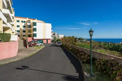a street with a street light next to a building at Pico Views by An Island Apart in Câmara de Lobos