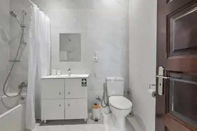 a bathroom with a toilet and a sink and a shower at Reis by KAAMAH in Ribeira Brava