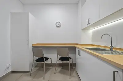 a kitchen with two chairs and a sink at Reis by KAAMAH in Ribeira Brava