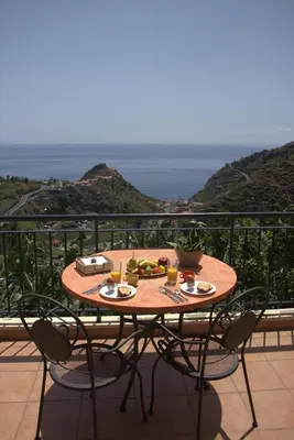 a table with food on top of a balcony at Casa Tabua in Ribeira Brava