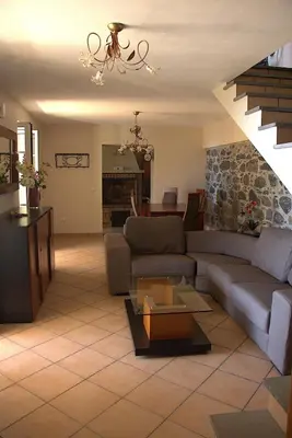 a room with a kitchen with a brick fireplace at Casa Tabua in Ribeira Brava