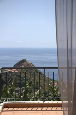 an empty road with a view of the ocean at Casa Tabua in Ribeira Brava
