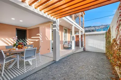 an outdoor patio with a table and chairs on a house at Casa NOLA by Susys Holidays in Funchal
