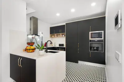 a kitchen with black cabinets and a white counter top at Casa NOLA by Susys Holidays in Funchal