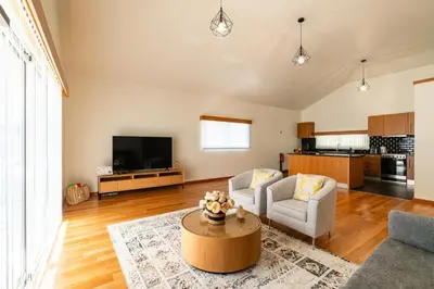 a living room with a couch and a table at Rosas House, private house with jacuzzi and BBQ in Estreito da Calheta