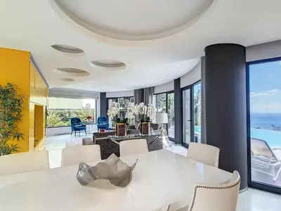 a dining room with a white table and chairs at Holiday Home VILLA BONSAI by Interhome in Arco da Calheta