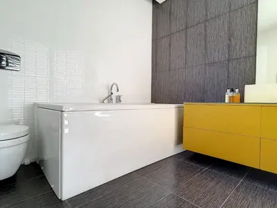 a bathroom with a tub and a sink and a toilet at Holiday Home VILLA BONSAI by Interhome in Arco da Calheta