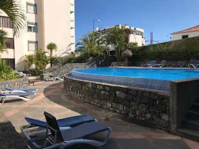 a swimming pool in a resort with lounge chairs at Apartment Funchal Wohnung mit Pool by Interhome in Funchal