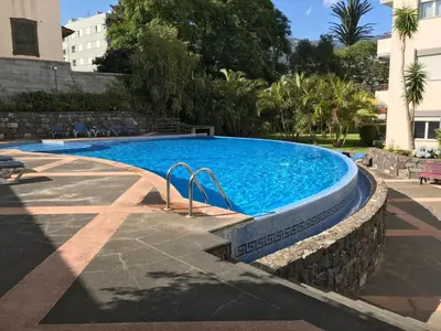 a large swimming pool with a stone wall around it at Apartment Funchal Wohnung mit Pool by Interhome in Funchal