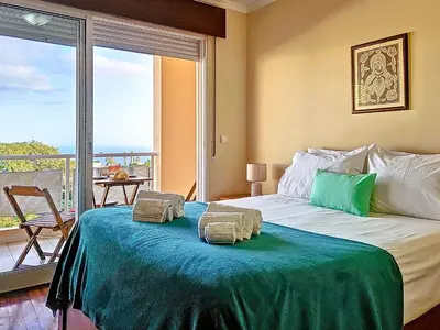 a bedroom with a bed with two pillows on it at Apartment Caniço Zentrum Wohnung by Interhome in Caniço