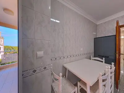 a dining room with a table and chairs and a window at Apartment Caniço Zentrum Wohnung by Interhome in Caniço