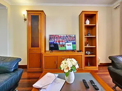 a living room with a couch and a tv at Apartment Caniço Zentrum Wohnung by Interhome in Caniço