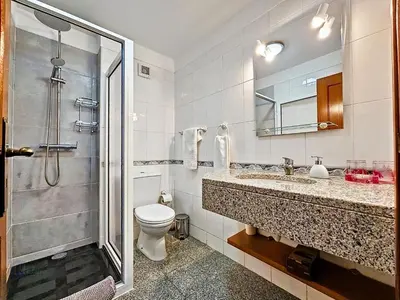 a bathroom with a toilet and a sink and a shower at Apartment Caniço Zentrum Wohnung by Interhome in Caniço