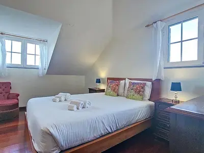 a bedroom with a bed with two towels on it at Holiday Home Haus Seixal by Interhome in Seixal