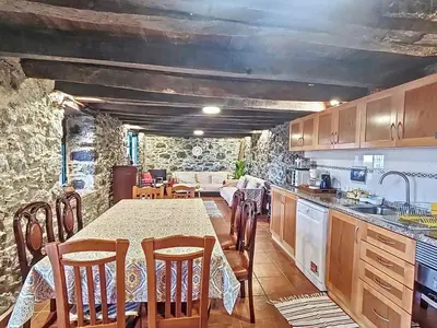 a kitchen with a table and some chairs and a table and a kitchen at Holiday Home Haus Seixal by Interhome in Seixal
