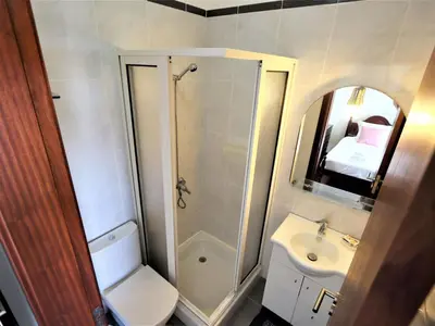 a bathroom with a toilet and a sink and a shower at Holiday Home Haus Seixal by Interhome in Seixal