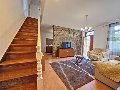 a living room with a staircase and a couch at Holiday Home Quinta do Serrado 2 by Interhome in Ribeira da Janela