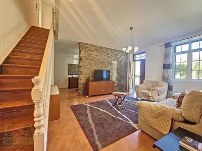 a living room with a couch and a tv at Holiday Home Quinta do Serrado 2 by Interhome in Ribeira da Janela