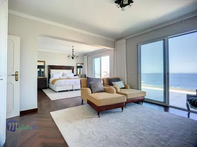 a living room with a bed and a bedroom with the ocean at Holiday Home PEARLS BEACH VILLA by Interhome in Porto Moniz