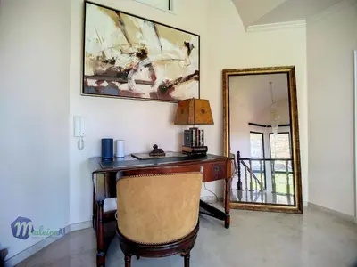 a desk with a lamp and a mirror in a room at Holiday Home PEARLS BEACH VILLA by Interhome in Porto Moniz
