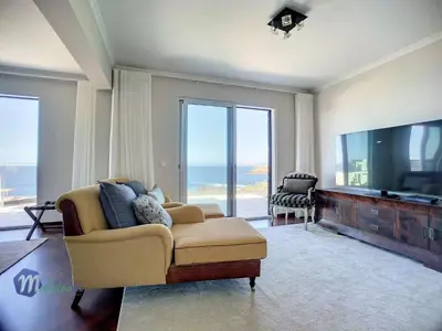 a living room with a couch and a flat screen tv at Holiday Home PEARLS BEACH VILLA by Interhome in Porto Moniz