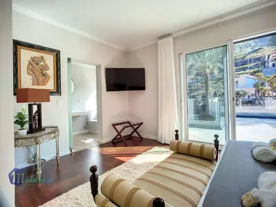 a living room with a bed and a large window at Holiday Home PEARLS BEACH VILLA by Interhome in Porto Moniz