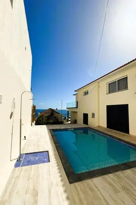 a swimming pool in the backyard of a house at Holiday Home PEARLS BEACH VILLA by Interhome in Porto Moniz