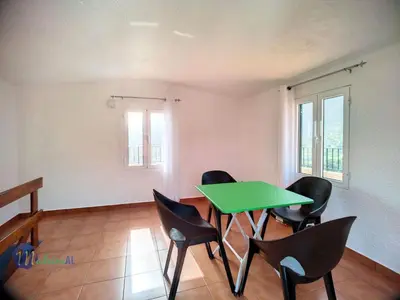 a room with a green table and chairs at Holiday Home Casa do Romaninho by Interhome in Porto da Cruz