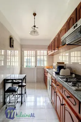 a kitchen with a table and a counter top at Apartment Wohnung in Funchal- in der Nähe von Farmers Market by Interhome in Funchal