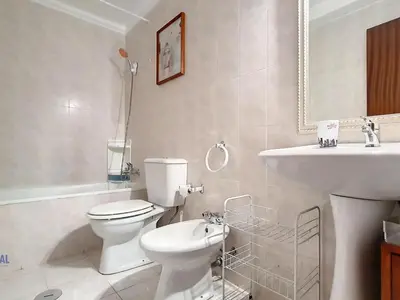 a white bathroom with a toilet and a sink at Apartment Wohnung in Funchal- in der Nähe von Farmers Market by Interhome in Funchal